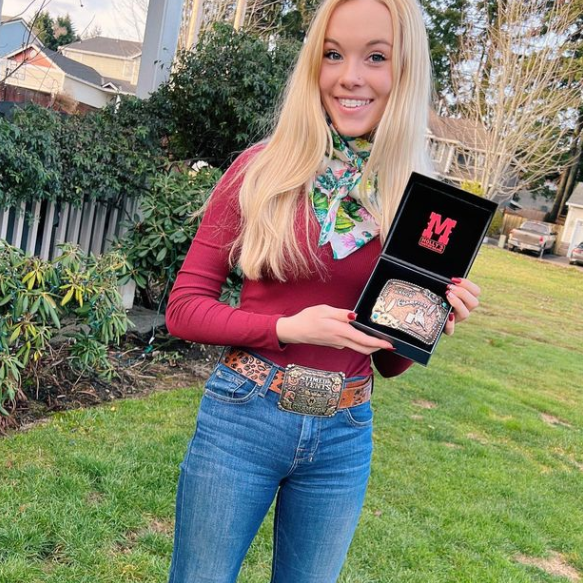 Woman with two western belt buckles